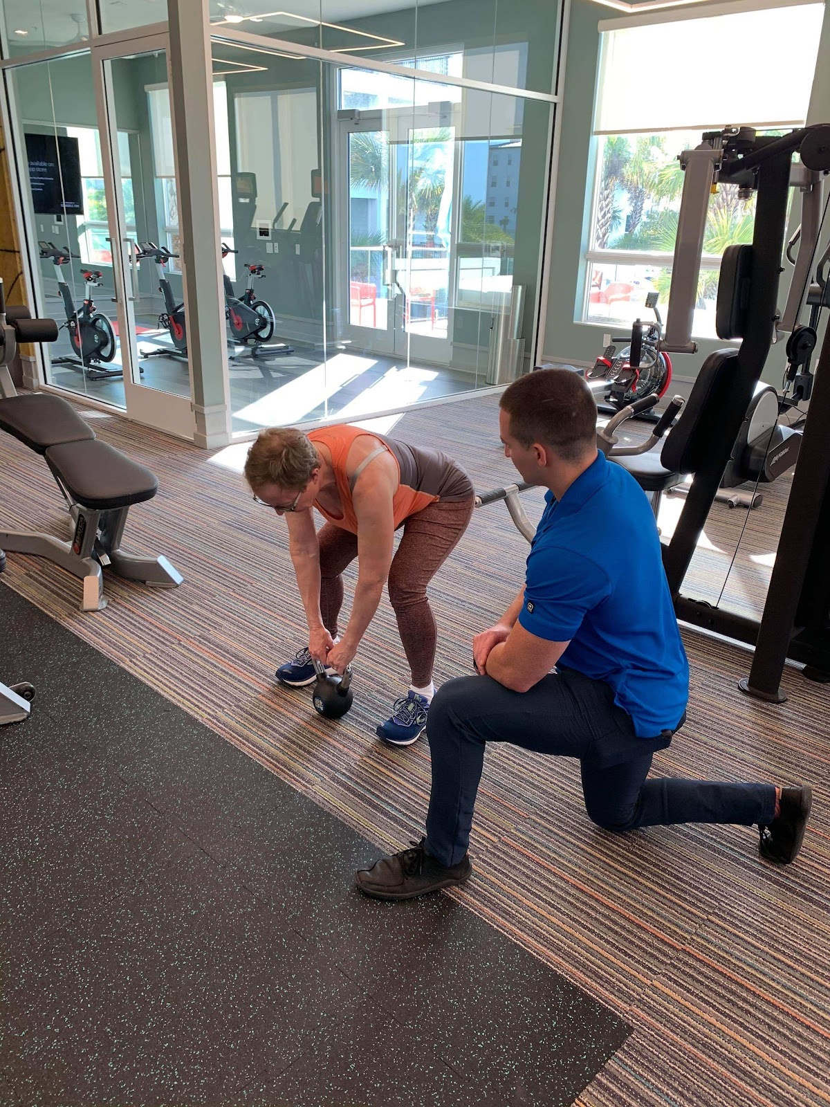 Jake coaching a client through a kettlebell deadlift